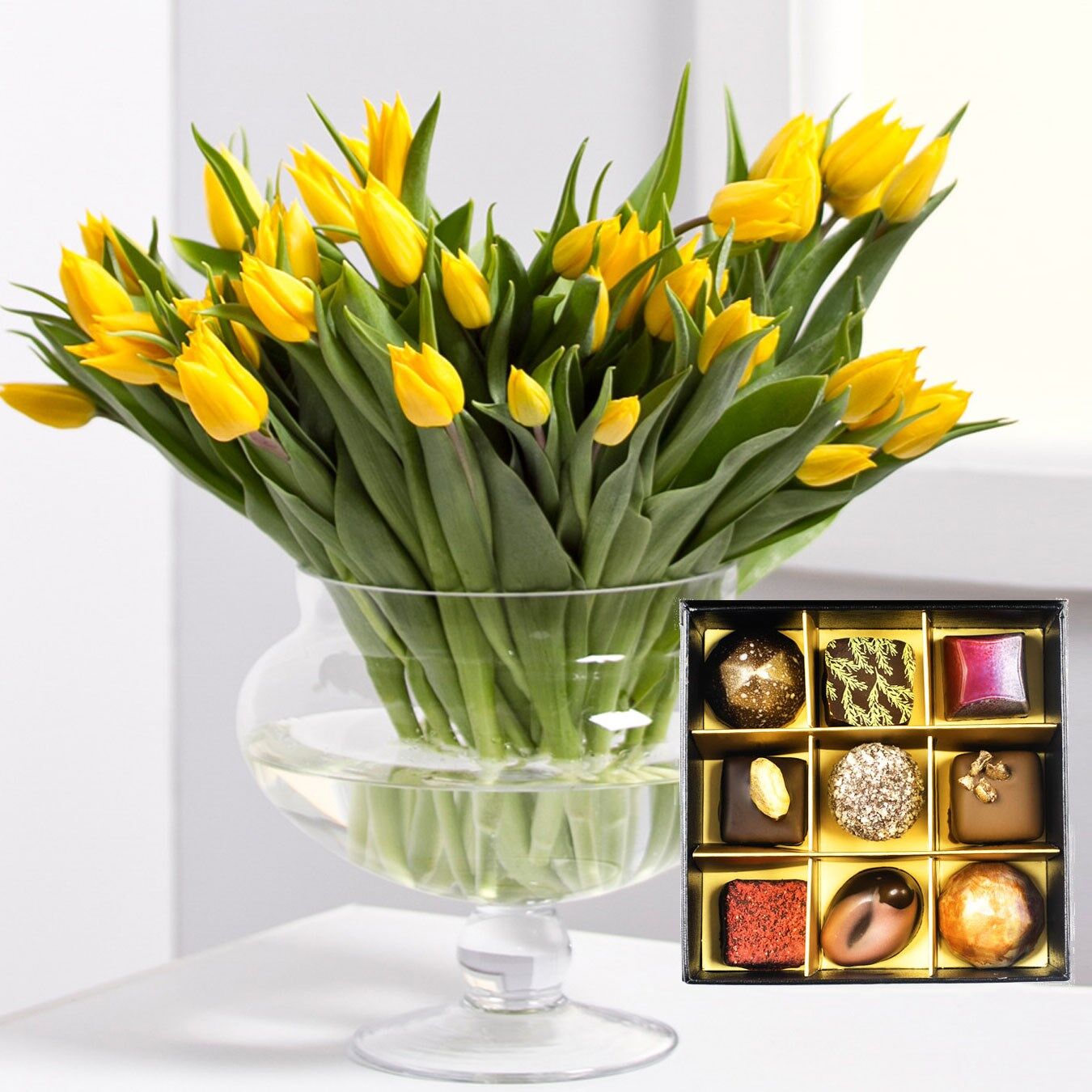 Bouquet of tulips with a box of chocolates